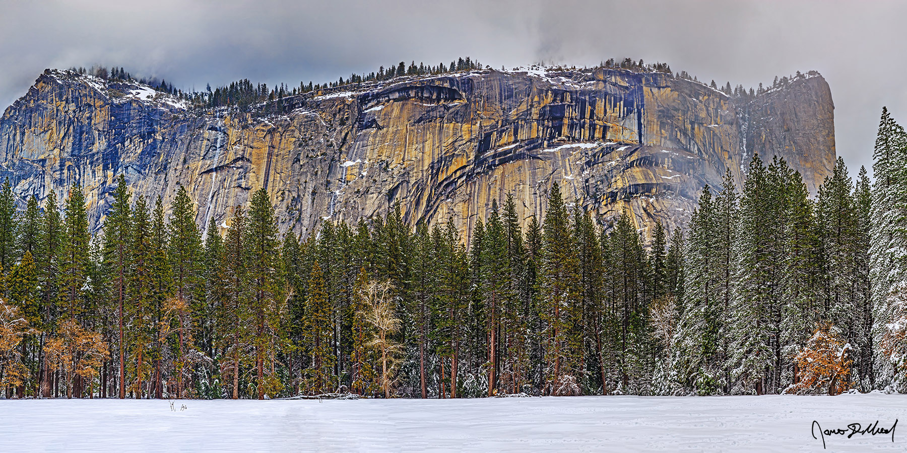 Royal Welcome Storm clouds cover North Dome in a veil as Royal Arch Cascade flows down the cliffs towards Yosemite Valley. Royal Arches and Washington Column rise high above.