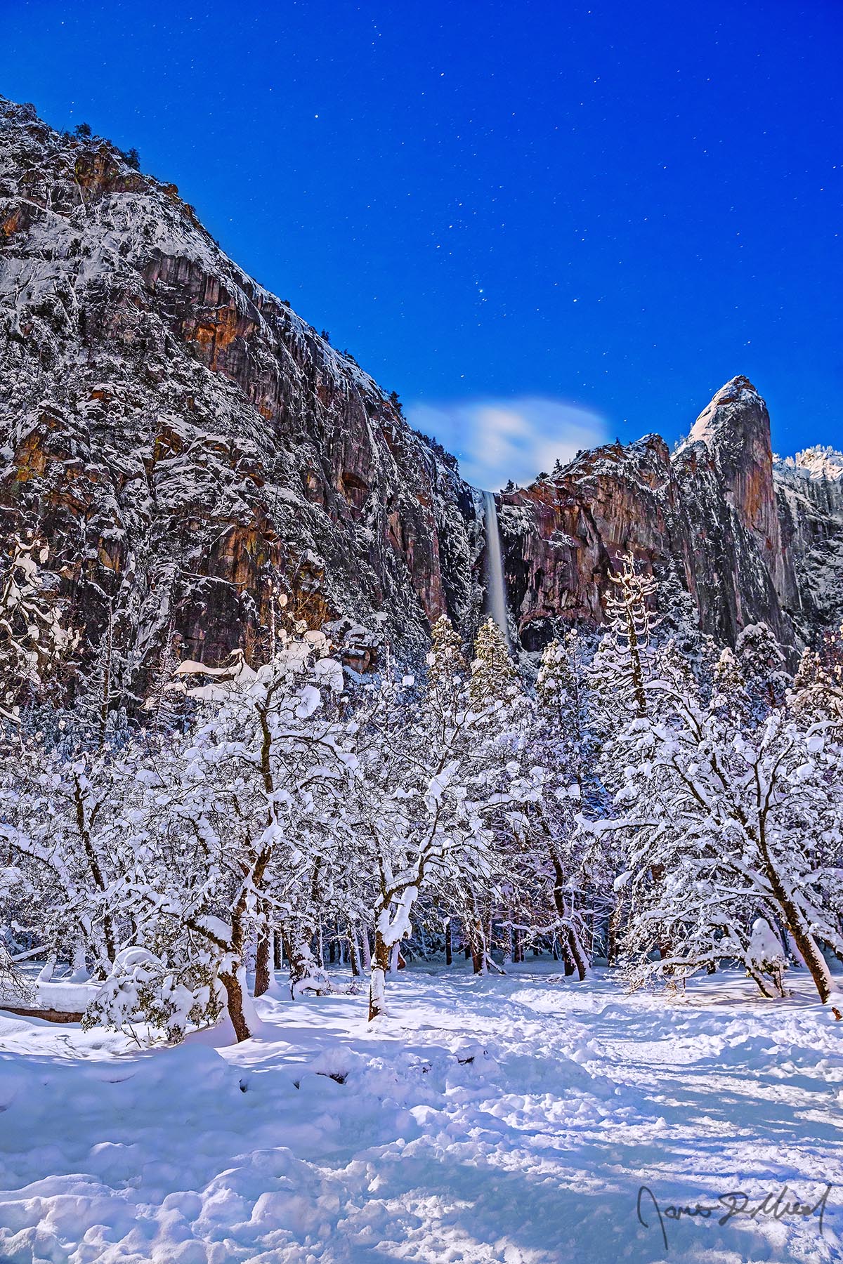 Orion’s Bride Orion's Belt shines bright in the night sky above a snow covered Bridalveil Meadow in the winter, as Bridalveil Fall tumbles 620 feet over the cliffs