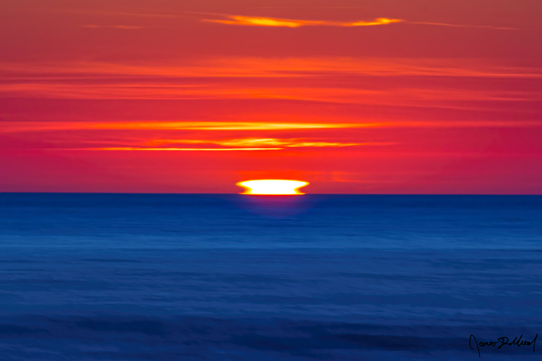 Split - Ducted Mock Mirage Sunset over the Pacific Ocean A ducted mock mirage at sunset over the Pacific Ocean along the Oregon Coast