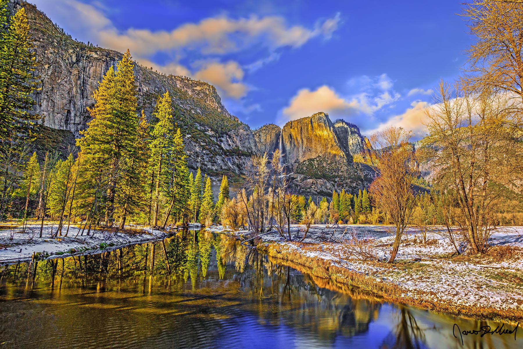 Peaceful Feeling Yosemite Falls plummets towards Yosemite Valley below while sunset illuminates the granite cliffs, the snow and the valley in a golden hue
