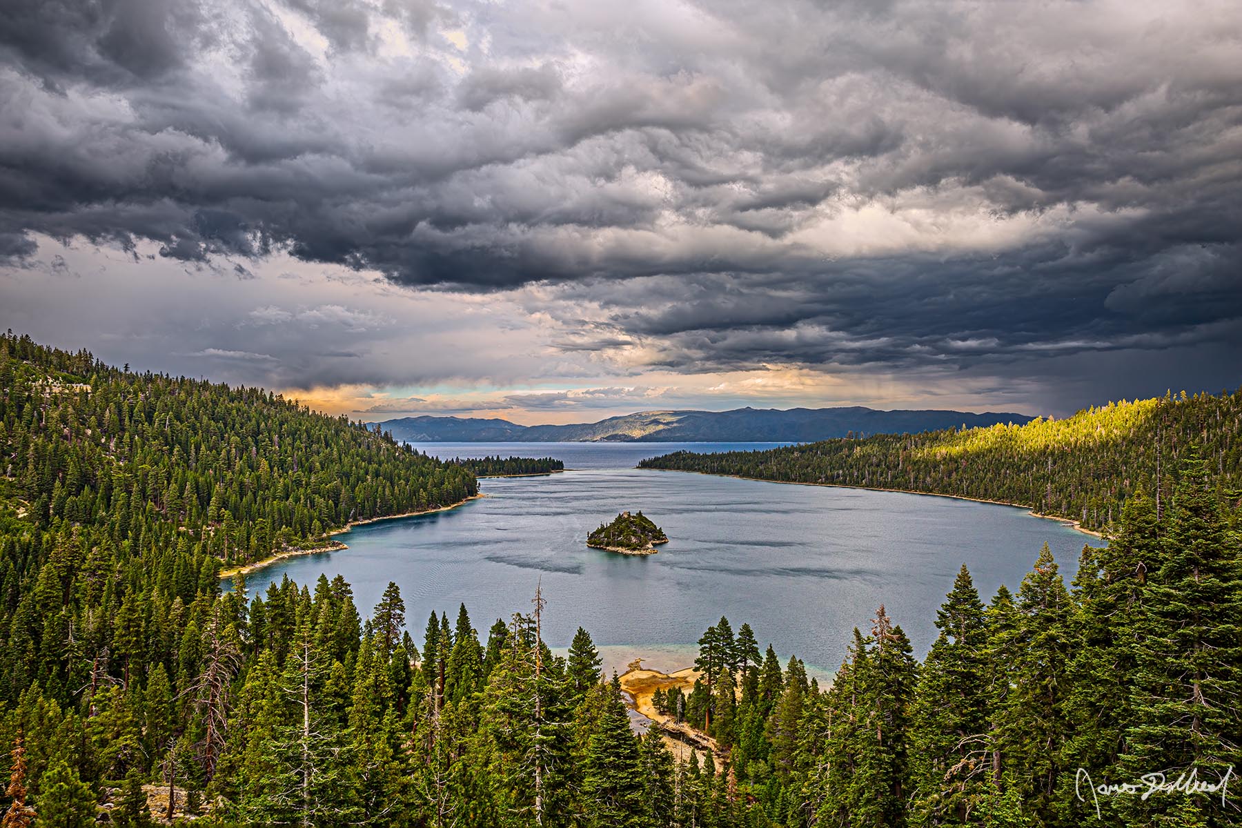 Ceiling Zero - Emerald Bay Thunderstorm Sunset over Lake Tahoe, Fannette Island, & the Sierra Nevada Storm clouds form over Lake Tahoe as a small patch of sunlight breaks through the cloud cover to illuminate the hills surrounding Emerald Bay.