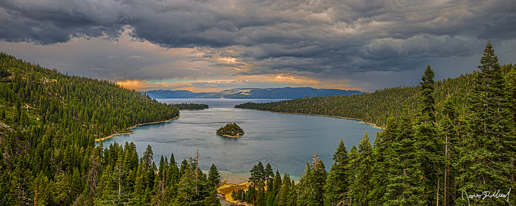A Storm Rolls In - Emerald Bay Sunset Thunderstorm over Fannette Island, Lake Tahoe & Sierra Nevada Storm clouds cover the skies above Emerald Bay and Lake Tahoe as sunlight illuminates the cloud breaks along the horizon and overhead