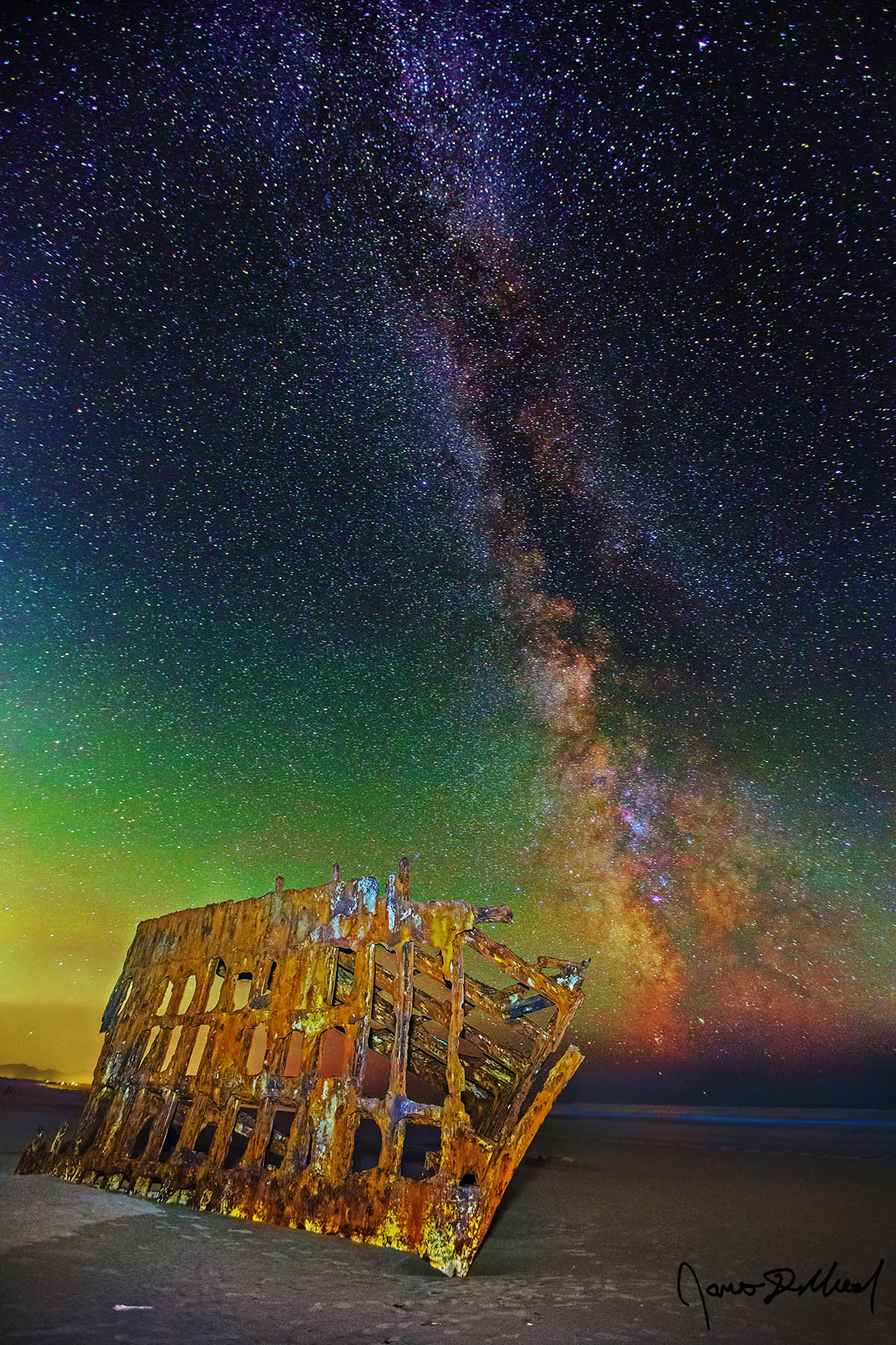 Starship - Bioluminescence and the Milky Way at the Wreck of the Peter Iredale on the Oregon Coast The Milky Way and as green airglow rise above the Wreck of the Peter Iredale at low tide and bioluminescence glows in the waters of Pacific Ocean.