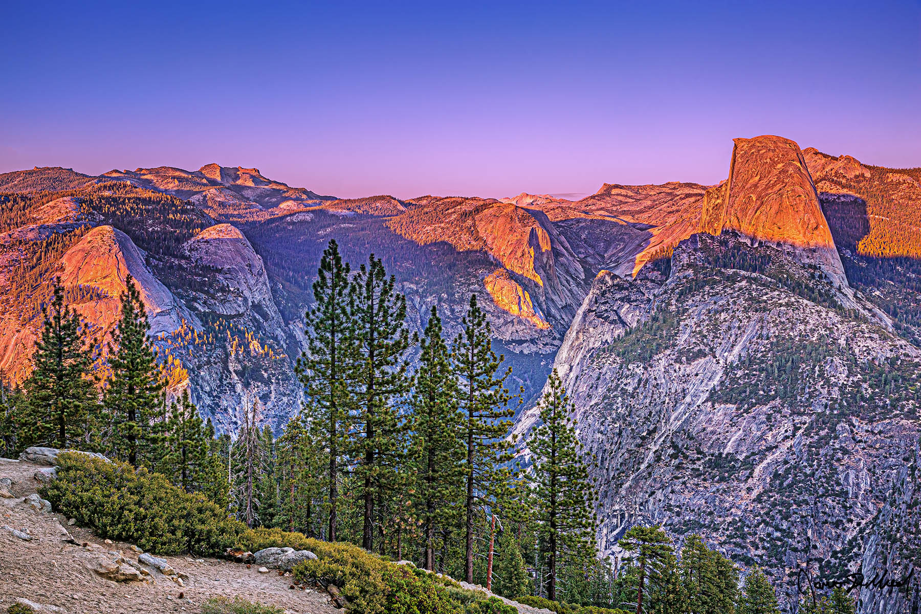 Crowned Alpenglow at Sunset illuminates Half Dome, Mount Watkins, Clouds Rest, North Dome and Basket Dome as soft pastel colors of the Belt of Venus lights the skies.