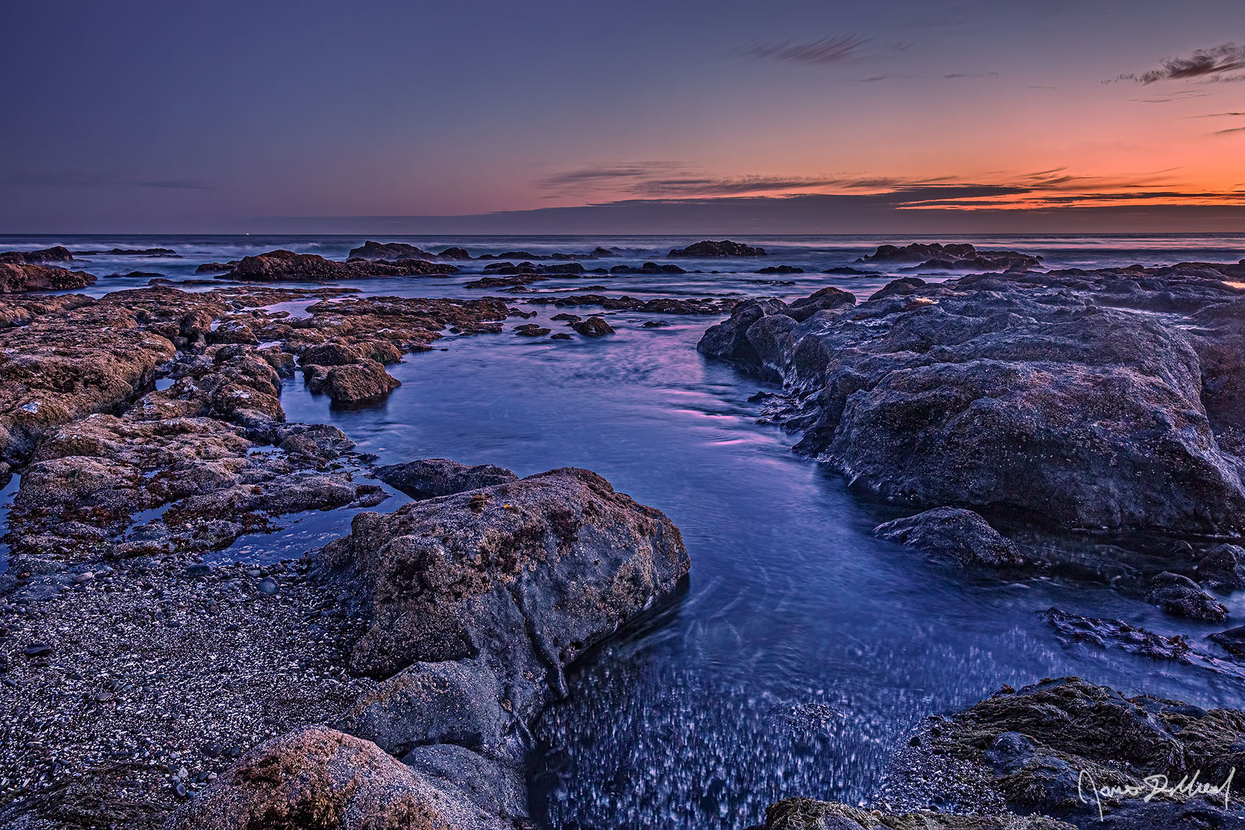 Ebb and Flow The last colors of sunset hang on over Tidepools and the Pacific Ocean as dusk sets in.
