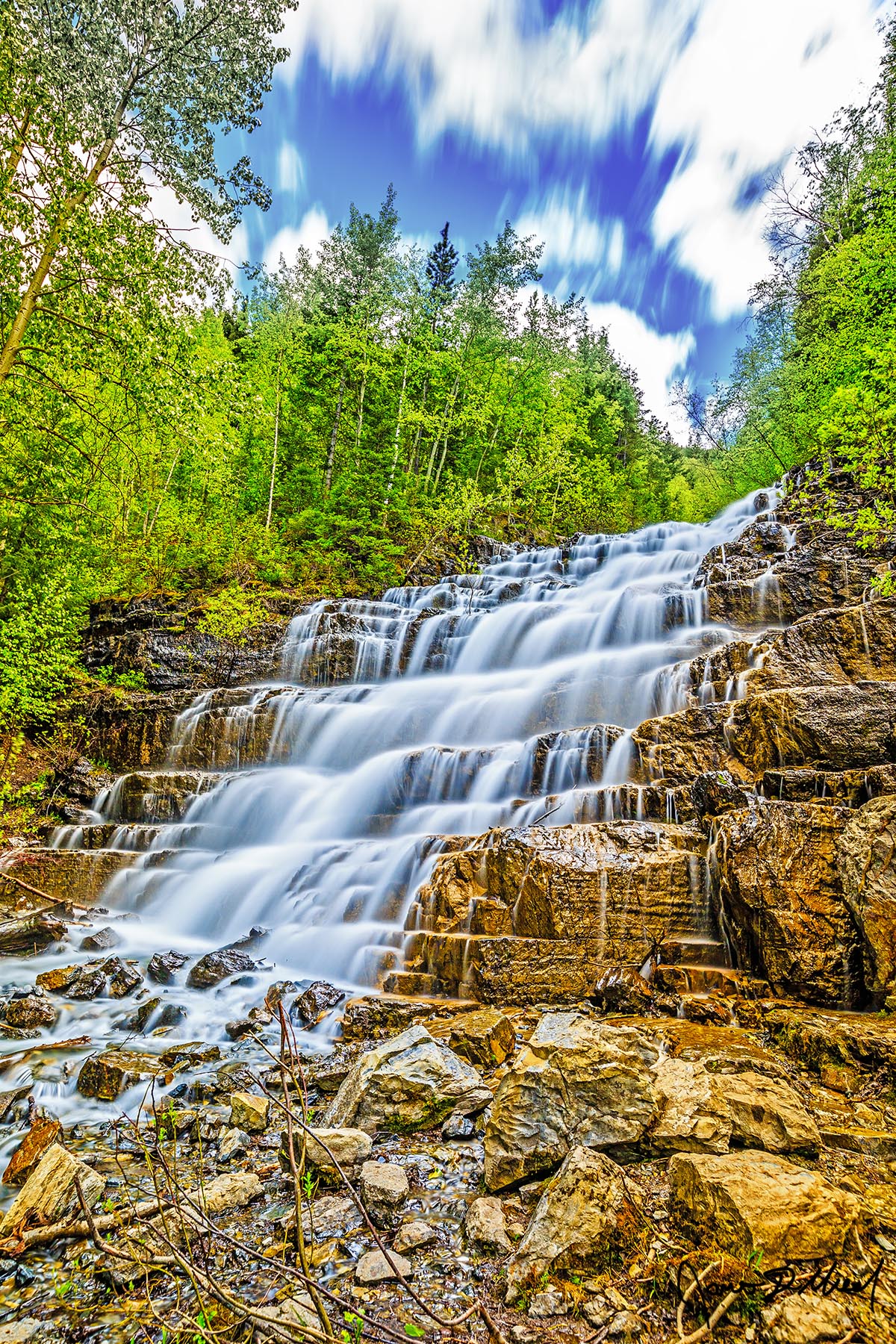 Silver Steps Silver Staircase Falls gracefully cascades 40 feet down the cliffs in Glacier National Park, paint the tiered cliffs in silver paint made of water.