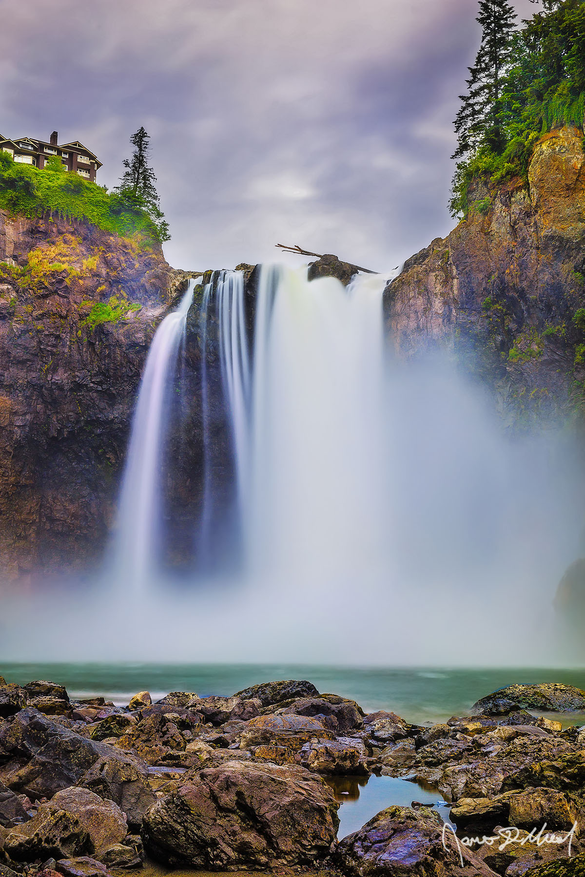 River Mist Mist flies up as the Snoqualmie River crash against the rocks as Snoqualmie Falls drops 268 feet over the cliffs and into a pool water in late spring.