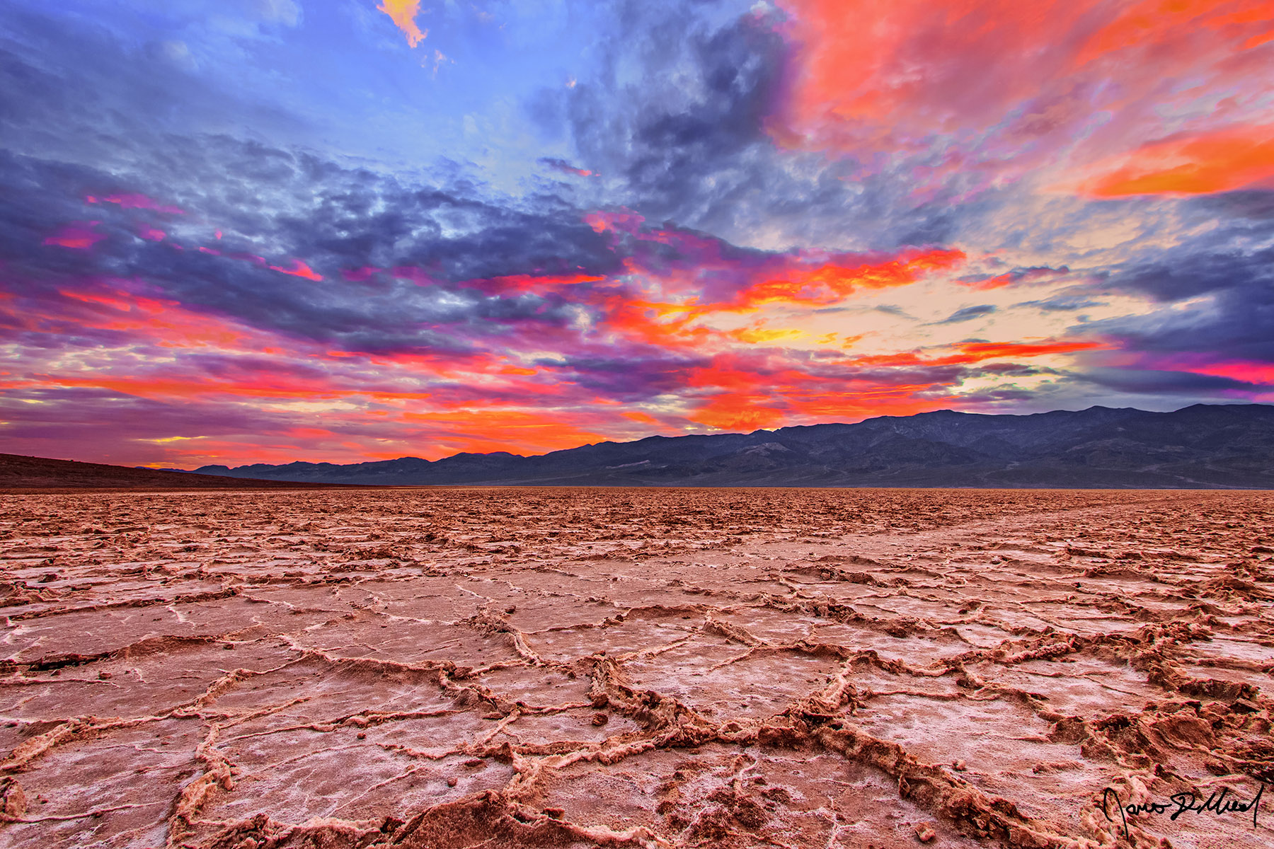 Nature’s Watercolor - Badwater Basin Salt Hexagons at Sunset, Death Valley National Park, California Like something out of a watercolor panting, sunset illuminates the clouds over Badwater Basin brilliant hues of color as the day draws to a close.