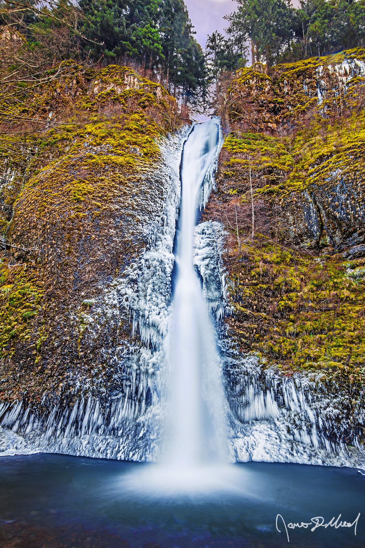 Horsetail Ice - Ice at Horsetail Falls during a Winter Sunset, Columbia River Gorge, Oregon Ice clings to the cliffs in the Columbia River Gorge during a cold spell, as Horsetail Falls gracefully tumbles over the cliffs and down into the pool of water.